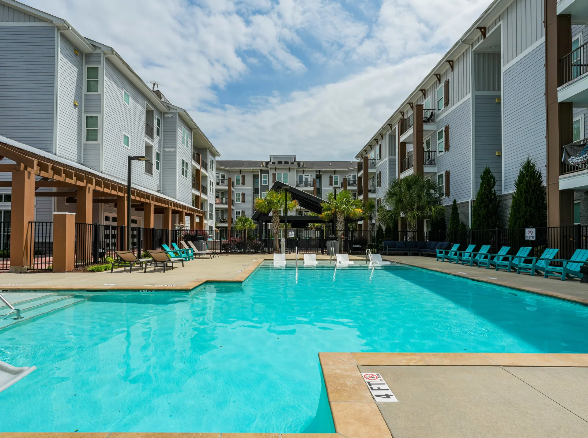 Resort-style swimming pool surrounded by apartments at The Pier Conway